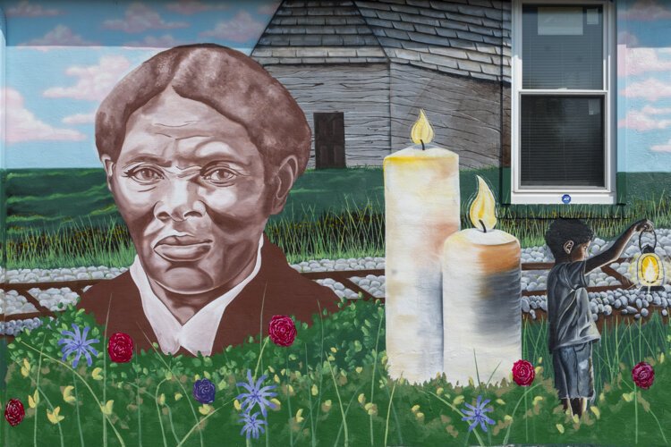 Graffiti HeArt, a  non-profit organization, engaged artists Stina Aleah, Davon Brantley, and Christa Childs for this Underground Railroad – Road to Freedom mural in Bedford.