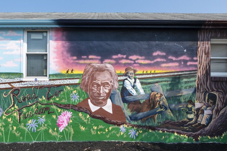 Graffiti HeArt, a  non-profit organization, engaged artists Stina Aleah, Davon Brantley, and Christa Childs for this Underground Railroad – Road to Freedom mural in Bedford.